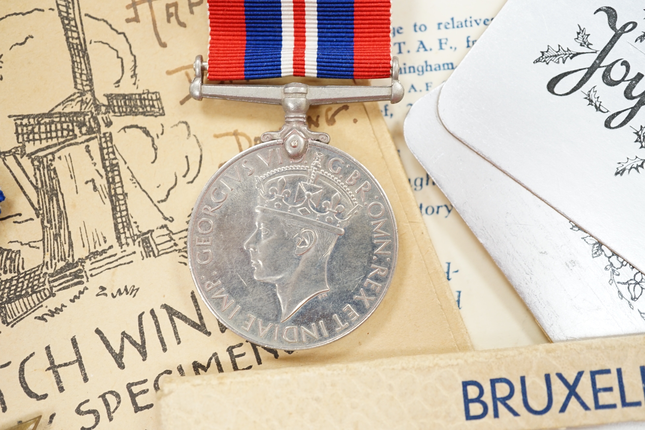 An RAF silver mug, and framed drawing of a map of Belgium and surrounding countries relating to 83rd Group Main HQ, Tactical Air Force 1944-45 together with four WWII medals in the original card, issue box; the Defence M